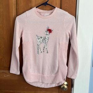 Adorable light pink polyester sweater with sequined reindeer.